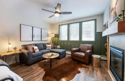 a living room with a couch and a fireplace at Premium Unit 3318 - Studio - Fraser Crossing Founders Pointe condo in Winter Park