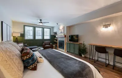 a bedroom with a bed and a living room at Premium Unit 3318 - Studio - Fraser Crossing Founders Pointe condo in Winter Park