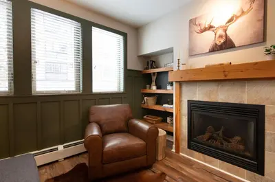 a living room with a chair and a fireplace at Premium Unit 3318 - Studio - Fraser Crossing Founders Pointe condo in Winter Park