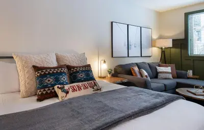 a living room with a bed and a couch at Premium Unit 3318 - Studio - Fraser Crossing Founders Pointe condo in Winter Park
