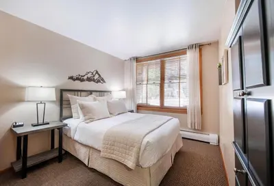 a bedroom with a large bed and a window at Premium Unit 1108 - One Bedroom - Zephyr Mountain Lodge condo in Winter Park