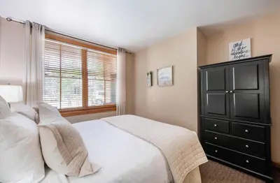 a bedroom with a bed and a dresser and a window at Premium Unit 1108 - One Bedroom - Zephyr Mountain Lodge condo in Winter Park