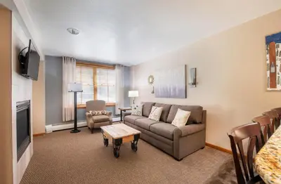 a living room with a couch and a table at Premium Unit 1108 - One Bedroom - Zephyr Mountain Lodge condo in Winter Park