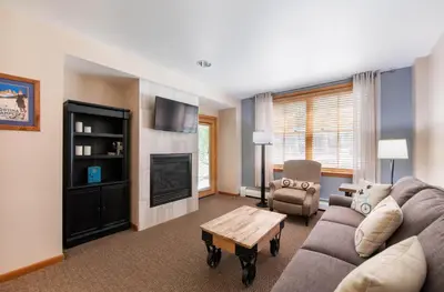 a living room with a couch and a fireplace at Premium Unit 1108 - One Bedroom - Zephyr Mountain Lodge condo in Winter Park