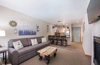 a living room with a couch and a table at Premium Unit 1108 - One Bedroom - Zephyr Mountain Lodge condo in Winter Park
