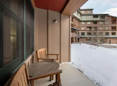 a balcony with a bench and a snow covered yard at Premium Unit 1108 - One Bedroom - Zephyr Mountain Lodge condo in Winter Park