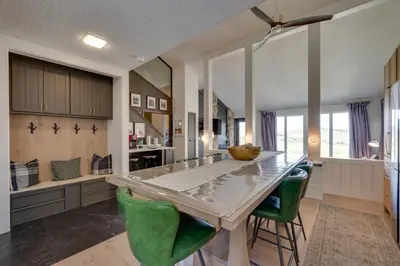 a kitchen with a large table and green chairs at Ski-InandSki-Out Granby Ranch Condo with Mountain View in Granby