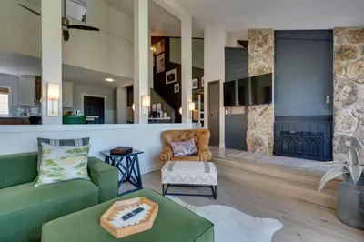 a living room with a couch and a table at Ski-InandSki-Out Granby Ranch Condo with Mountain View in Granby