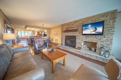 a living room with a couch and a fireplace at Pines 2116 by SummitCove Lodging in Keystone