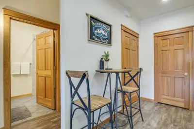 a room with two stools and a table in a room at Winter Park Condo with Balcony and Mtn Views! in Winter Park
