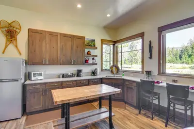 a kitchen with wooden cabinets and a wooden table at Cozy Fraser Cabin with Views and Moose Sightings! in Fraser