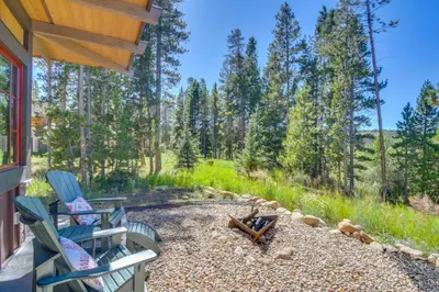 a backyard with two chairs and a fire pit at Cozy Fraser Cabin with Views and Moose Sightings! in Fraser