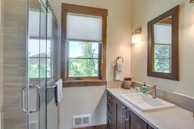 a bathroom with a shower and a sink and a glass shower backdoor at Cozy Fraser Cabin with Views and Moose Sightings! in Fraser