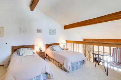 two beds in a room with a balcony at Fraser Mountain Retreat with Community Amenities! in Fraser