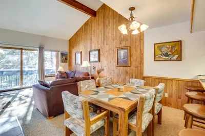 a dining room with a table and chairs and a couch at Fraser Mountain Retreat with Community Amenities! in Fraser