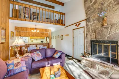 a living room with a couch and a fireplace at Fraser Mountain Retreat with Community Amenities! in Fraser