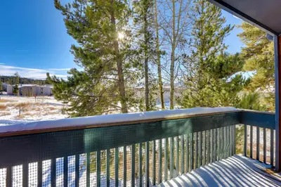 a balcony with a view of trees and snow at Fraser Mountain Retreat with Community Amenities! in Fraser