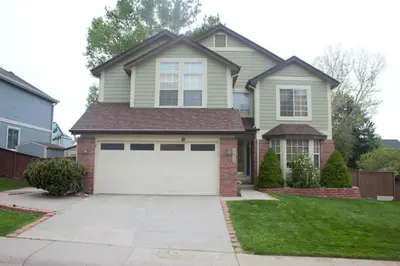 a house with a white garage door at Amazing 4 Bedroom House with nice Backyard in Littleton