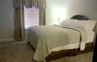 a bedroom with a large white bed with a window at Amazing 4 Bedroom House with nice Backyard in Littleton