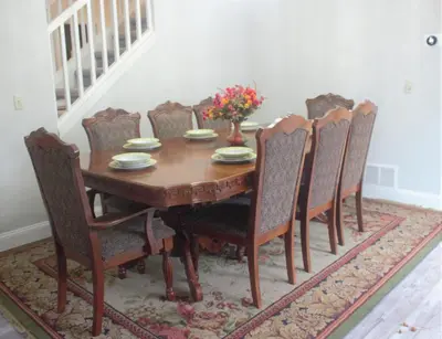 a dining room table and chairs with a table and a vase of flowers at Amazing 4 Bedroom House with nice Backyard in Littleton