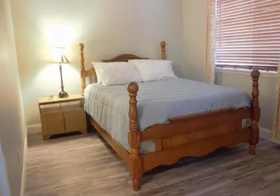 a bedroom with a bed and a lamp on a table at Amazing 4 Bedroom House with nice Backyard in Littleton