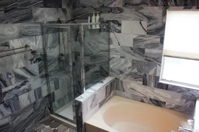 a bathroom with a shower and a bath tub at Amazing 4 Bedroom House with nice Backyard in Littleton