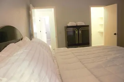 a bedroom with a white bed and a mirror at Amazing 4 Bedroom House with nice Backyard in Littleton