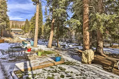 a patio with a table and chairs in the snow at 3 Mi to National Park Cozy Studio in Grand Lake in Grand Lake
