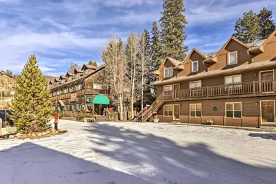 a snow covered yard in front of a lodge at 3 Mi to National Park Cozy Studio in Grand Lake in Grand Lake