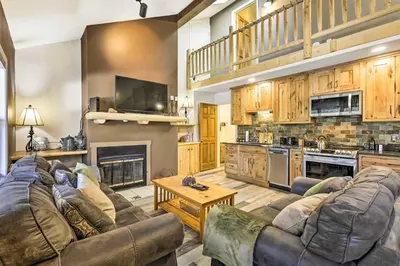 a large living room with couches and a kitchen at Walk to Grand Lake Riverfront Gem with Fireplace! in Grand Lake