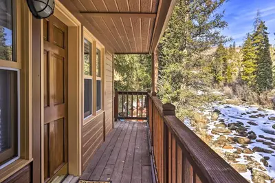 a porch of a house with snow on the ground at Walk to Grand Lake Riverfront Gem with Fireplace! in Grand Lake