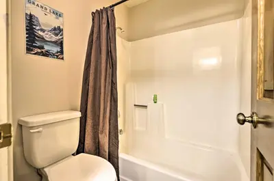 a bathroom with a toilet and a shower at Walk to Grand Lake Riverfront Gem with Fireplace! in Grand Lake