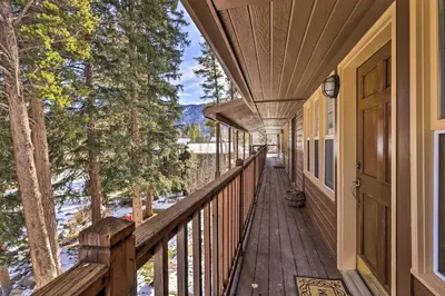 a porch of a house with a wooden deck at Walk to Grand Lake Riverfront Gem with Fireplace! in Grand Lake