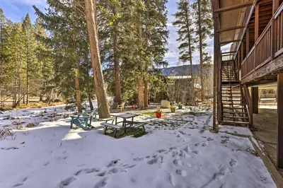 a picnic table in the snow next to a building at Walk to Grand Lake Riverfront Gem with Fireplace! in Grand Lake