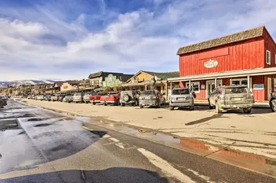 a row of cars parked on the side of a street at Walk to Grand Lake Riverfront Gem with Fireplace! in Grand Lake