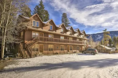 a large house with a car parked in front of it at Walk to Grand Lake Riverfront Gem with Fireplace! in Grand Lake