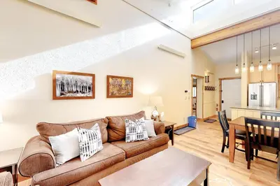 a living room with a couch and a table at Coziest Condo in Winter Park