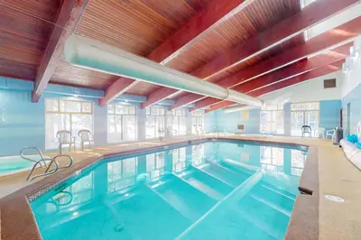 a large indoor swimming pool in a building at Coziest Condo in Winter Park