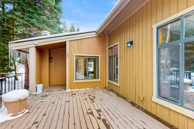 a porch of a house with a wooden deck at Coziest Condo in Winter Park