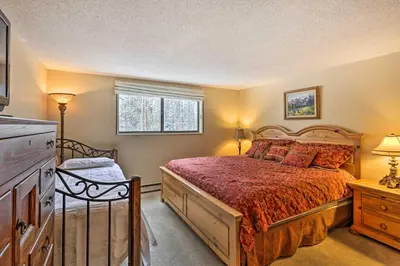 a bedroom with a large bed and a window at Gorgeous Winter Park Condo with Private Deck! in Winter Park