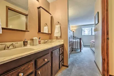 a bathroom with a sink and a mirror at Gorgeous Winter Park Condo with Private Deck! in Winter Park