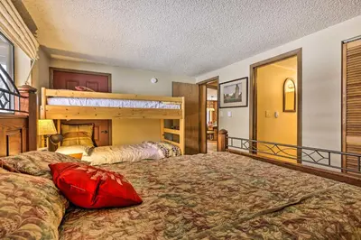 a bedroom with two beds and a bunk bed at Gorgeous Winter Park Condo with Private Deck! in Winter Park