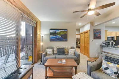 a living room with a couch and a table at Patio and Mountain Views Central Grand Lake Condo! in Grand Lake