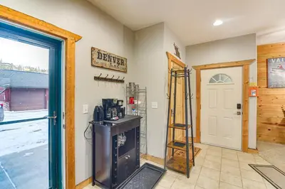 a room with a door with a stove and a ladder at Patio and Mountain Views Central Grand Lake Condo! in Grand Lake