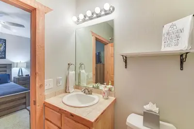 a bathroom with a sink and a mirror at Patio and Mountain Views Central Grand Lake Condo! in Grand Lake
