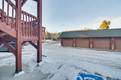 a wooden ramp in the snow next to a building at Patio and Mountain Views Central Grand Lake Condo! in Grand Lake
