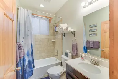 a bathroom with a tub and a sink and a toilet at Patio and Mountain Views Central Grand Lake Condo! in Grand Lake