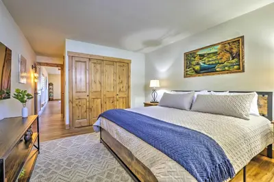 a bedroom with a king sized bed and a television at MtnandLake Views and 3 Mi to Skiing Dillon Condo in Dillon