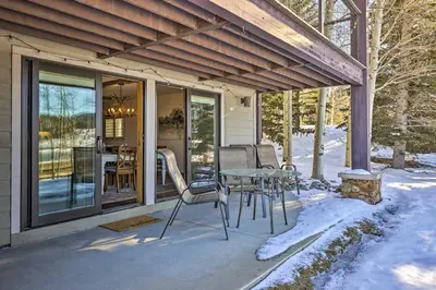 a patio with a table and chairs in the snow at MtnandLake Views and 3 Mi to Skiing Dillon Condo in Dillon