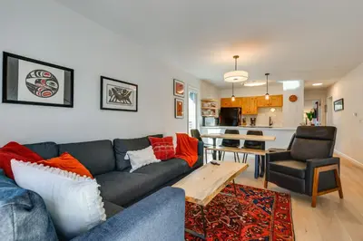 a living room with a couch and a table at Walk to Winter Park Bus From Fraser Condo! in Fraser
